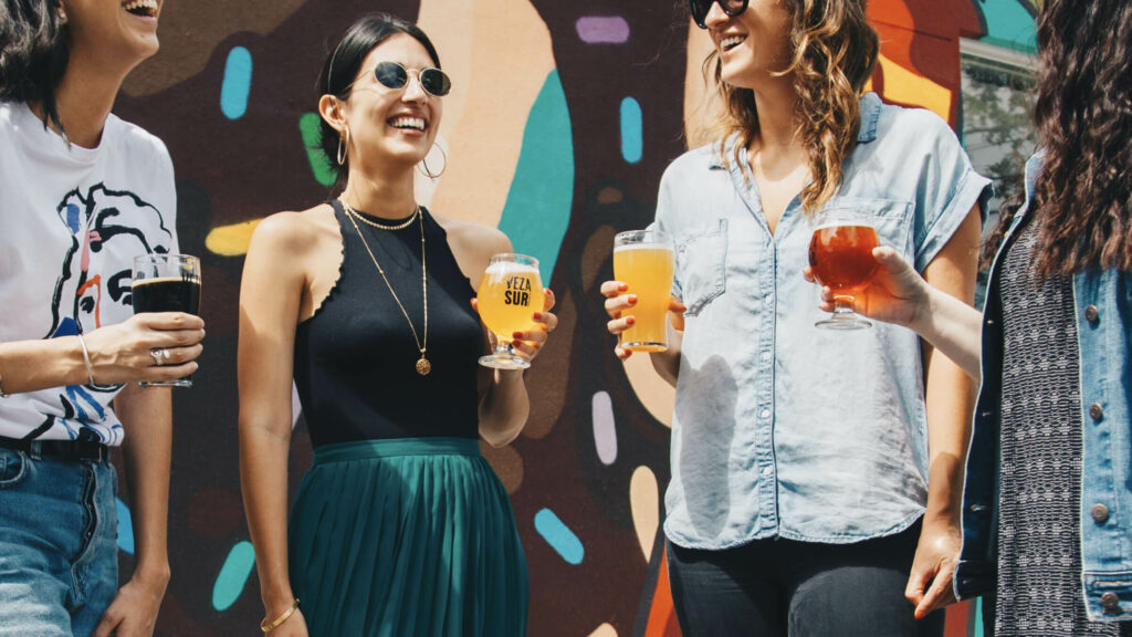 A group of women drinking beer outdoors